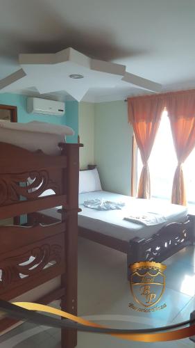 a small bedroom with a bed and a window at Hotel Bucarica Plaza in Bucaramanga