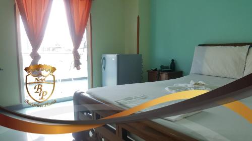 a bed in a room with a large window at Hotel Bucarica Plaza in Bucaramanga