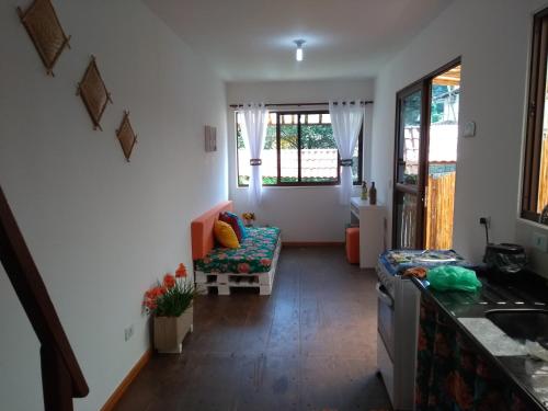 a living room with a couch and a table at Casa Linda Ilhabela in Ilhabela