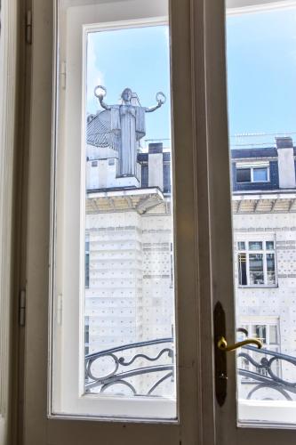 a view of a statue from a window at Pension Riedl in Vienna