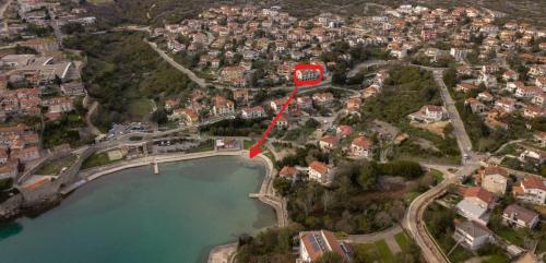 arial view of a city with a red map at Apartman"Petra" in Krk