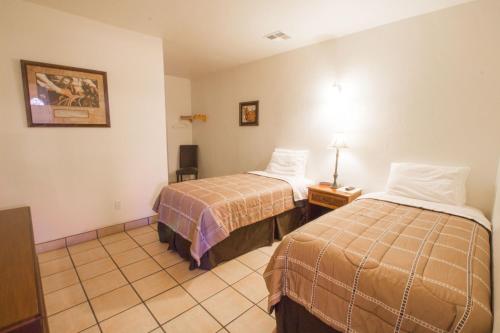 A bed or beds in a room at Stagecoach Suites
