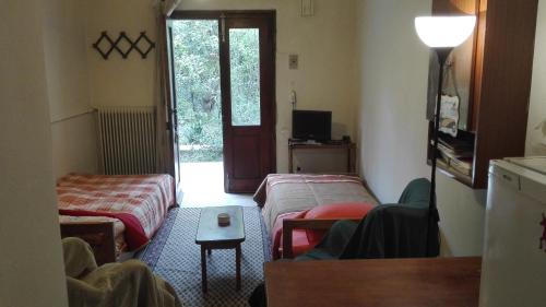 a room with two beds and a door to a yard at route 66 New Mexico 6 in Rethymno Town