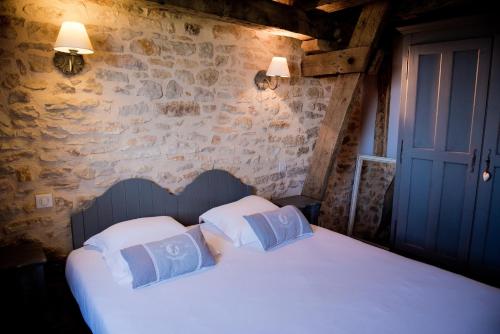 アルヴィーニャックにあるGîte 8 pers du Château de Cantecorのベッドルーム1室(白いシーツと青い枕のベッド1台付)