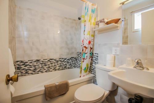 a bathroom with a toilet and a sink at The White Horse Motel in Charlottetown