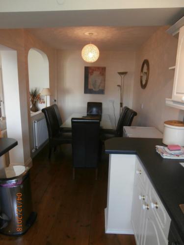 a kitchen with a table and chairs in a room at Riverside House in Bideford