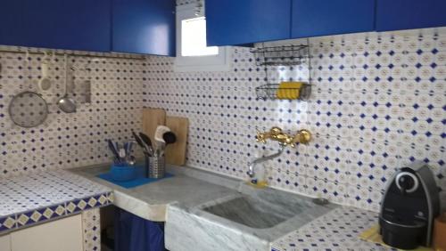 cocina con fregadero y azulejos azules y blancos en nel cuore di sestri, en Sestri Levante