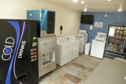 a room with a soda machine and a refrigerator at Theroff's Motel in Washington