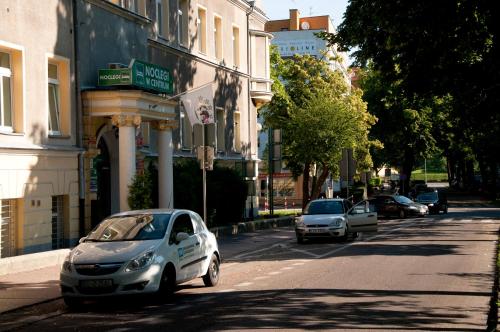a car parked on the side of a city street at Centrum Kołobrzeg in Kołobrzeg
