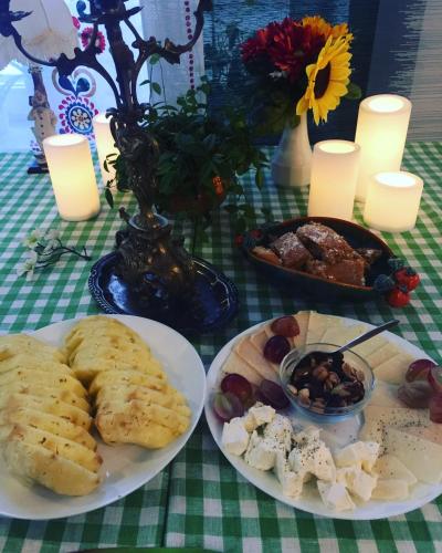 a table with plates of food on a table with candles at B&B Chardas in Bük