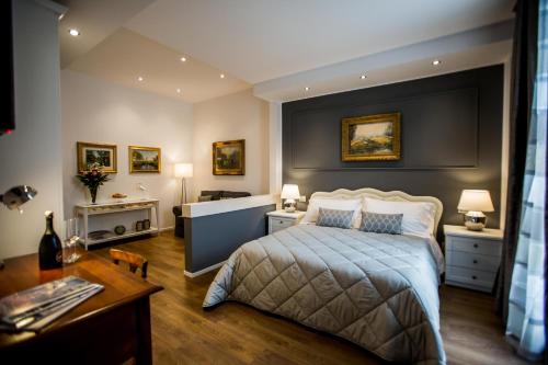 a bedroom with a large bed and a desk and a desk at Arena Suite in Verona