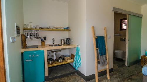 a kitchen with a blue refrigerator in a room at BEACHES Bonaire in Kralendijk