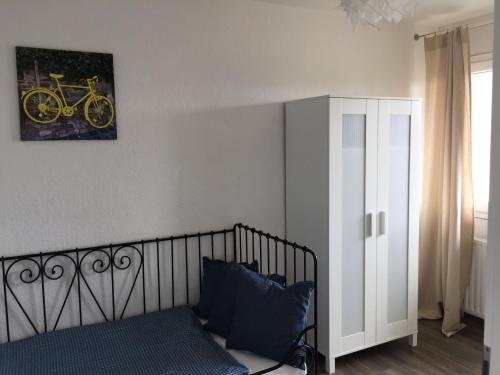a bedroom with a bed and a picture of a bike on the wall at Deluxapartment in Kaiserslautern