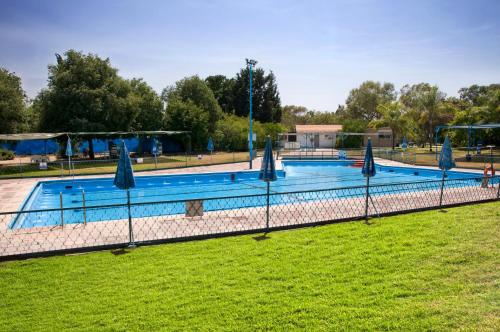 a large swimming pool with closed umbrellas at Nes Ammim Hotel in Nes Ammim