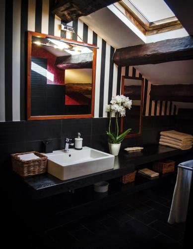 a bathroom with a white sink and a mirror at La Terrazza Sui Tetti in Senigallia