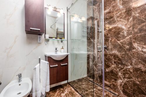 a bathroom with a sink and a glass shower at Enjoy the Silence, Nature and Sea in Kraljevica