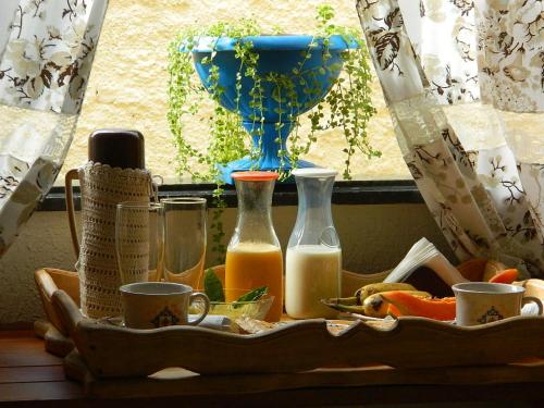 a tray with bottles of juice and a window at Pousada Kasabela Residence in Prea