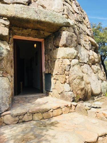 an entrance to a stone building with a door at Il Nuraghe del lago Coghinas in Oschiri