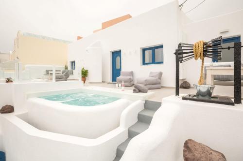 a white house with a jacuzzi tub at Amera Suites in Fira