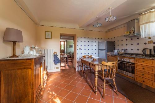a kitchen with a table and some chairs in it at Casa Orsolini in Lucca