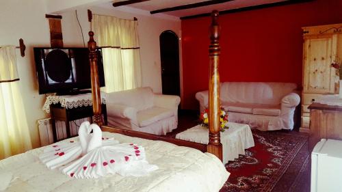 a bedroom with a bed and a living room at Hostal La Magia de Uyuni in Uyuni