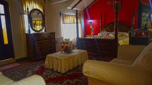 a bedroom with a bed and a table with flowers on it at Hostal La Magia de Uyuni in Uyuni