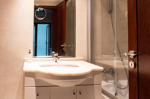 a bathroom with a sink and a shower at Apartamento Arrabida in Lisbon