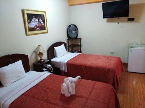 Postel nebo postele na pokoji v ubytování Hotel Suite Plaza