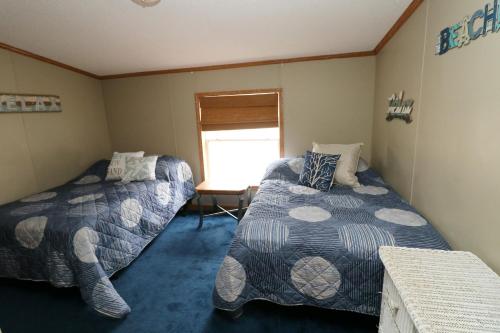 a room with two beds and a window at Island Club #67 in Put-in-Bay