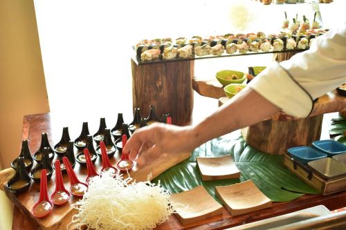 a chef preparing rice on a table with wine bottles at Crown Paradise Club All Inclusive in Puerto Vallarta