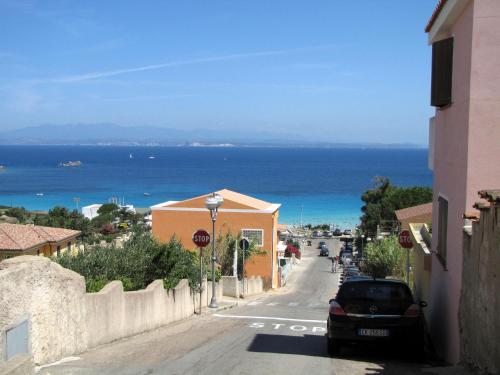 a street in a town with a view of the ocean at Hotel Corallaro in Santa Teresa Gallura