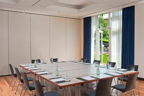a large conference room with a long table and chairs at Radisson Blu Park Hotel & Conference Centre in Dresden