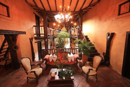 a room with a table and chairs and a chandelier at Hotel Boutique Quinta Tibigaro in San Vicente de Chucurí