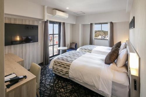 Postel nebo postele na pokoji v ubytování Hotel Mystays Kagoshima Tenmonkan Annex