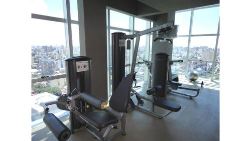 a gym with two tread machines in a room with windows at Amazing Apartament in Buenos Aires