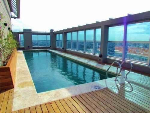 a swimming pool on top of a building at Amazing Apartament in Buenos Aires