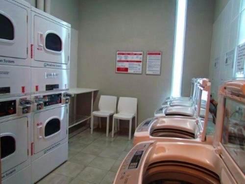a hospital room with washing machines and a table and chairs at Amazing Apartament in Buenos Aires
