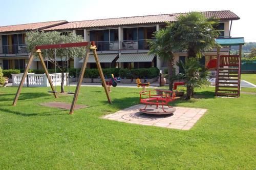 a park with a swing set and a playground at Residence La Margherita in Lazise