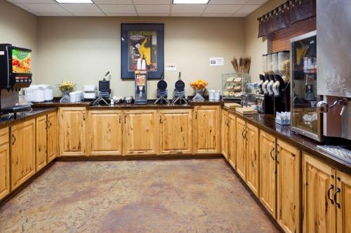 a restaurant with wooden cabinets in a room at AmericInn by Wyndham Fargo Medical Center in Fargo