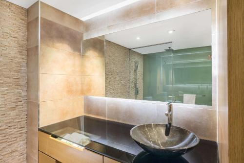 a bathroom with a sink and a mirror at Ramada Plaza by Wyndham Prince George in Prince George