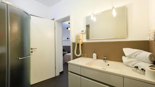 a bathroom with a sink and a mirror at Wellness Villa Istriana in Umag