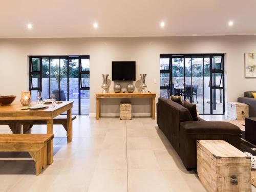 a living room with a couch and a table at The Greens Guest House in Knysna