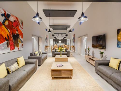 a living room with couches and a coffee table at The Greens Guest House in Knysna