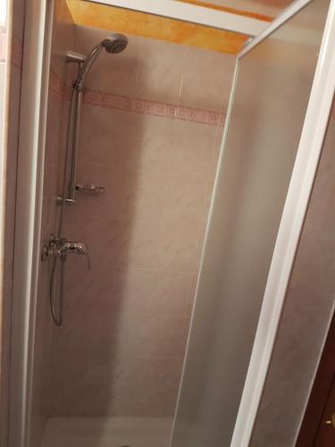 a shower in a bathroom with a glass door at casa Belvedere in San Siro