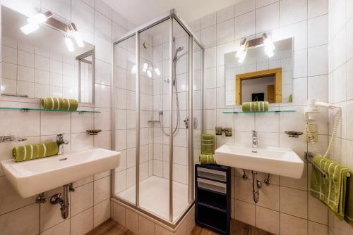 a bathroom with two sinks and a shower at Haus Central in Serfaus