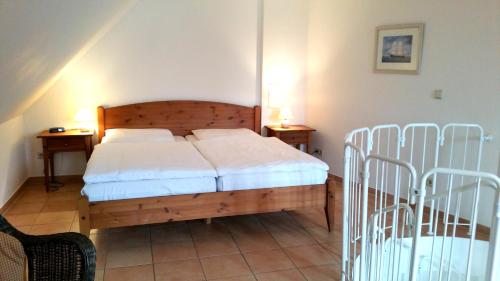 a bedroom with a bed and two night stands at Maisionette Wohnung im Hafenmeisterhaus Lauterbach in Lauterbach