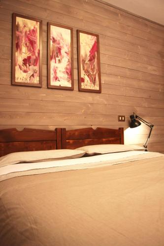 a bedroom with three pictures on the wall and a bed at Lu Garun Rus in Valdieri