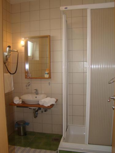 a bathroom with a sink and a tub and a mirror at Villa Lipa in Zadar