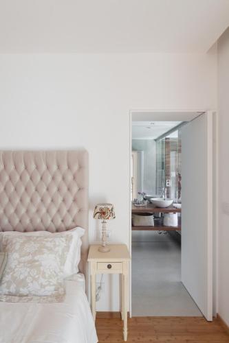a bedroom with a bed and a table and a mirror at Quinta do Fontelo in Vouzela