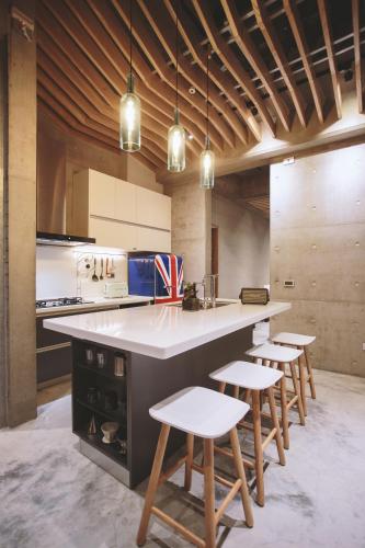 a kitchen with a large counter with stools in it at 墾丁 住在Zhuzai in Checheng